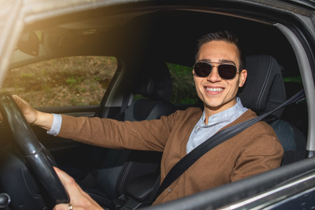 A happy CAucasian man with sunglasses sitting in the car and smilingの写真素材