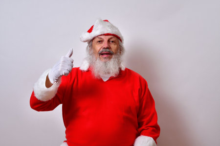 A Santa Claus showing thumbs up for a Merry Christmasの写真素材