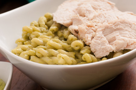 grilled chicken and spiral pasta with fresh organic peasの写真素材
