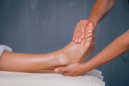 Close-up of woman doing foot massage at spa.の写真素材