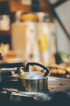 A stainless steel kettle on the stoveの写真素材