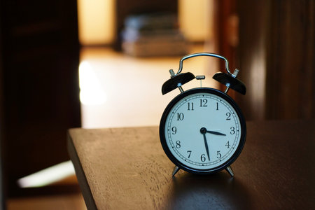 A classic alarm clock in a dark room