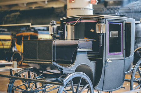 A black old vintage carriage in a museumの写真素材