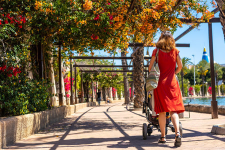A young woman with her son in the car enjoying the holidays in the Parque de las Naciones in the town of Torreviejaの写真素材