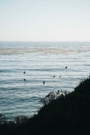 A peaceful waterscape and people swimming near the shoreline, Malibu, Californiaの写真素材