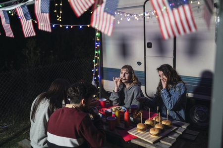 A group of young Spanish people enjoying their time during BBQ picnic on US Independence day at...