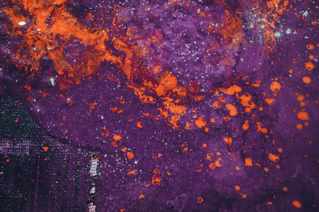 An abstract marble painting with mixed orange and purple colors in the waterの写真素材