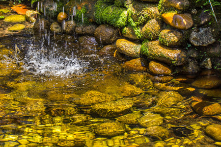 A cascade and lake with rocksの写真素材