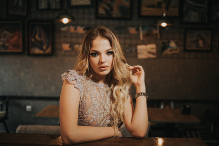 A blonde female posing in a cafeの写真素材