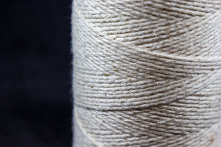 A closeup shot of a white twine roll on a black background