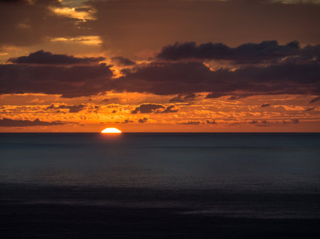 A mesmerizing view of the orange sunset over the sea in the Lanzarote islandの写真素材