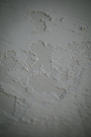 A vertical closeup shot of a textured cracked paint surfaceの写真素材
