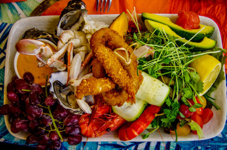 A closeup shot of seafood with fruits and vegetablesの写真素材