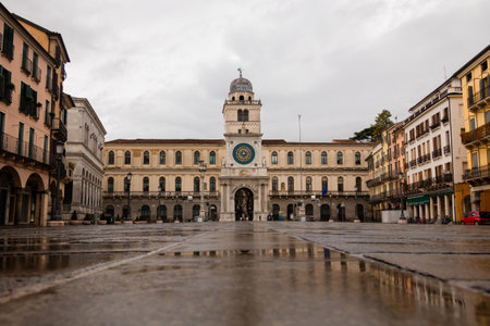 old italian square in rainy day with water reflections and old buildingsの写真素材