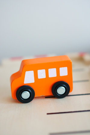 Wooden orange colored toy bus on tabの写真素材