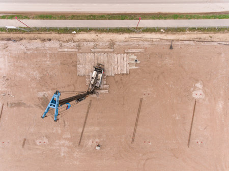 An aerial shot of a pile-driving machine at a construction siteの写真素材