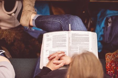 An overhead shot of a female reading the Bible during a church gathering
