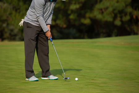 A male playing golf in the fieldの写真素材