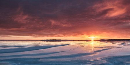 A photo of the sunset over the frozen seaの写真素材