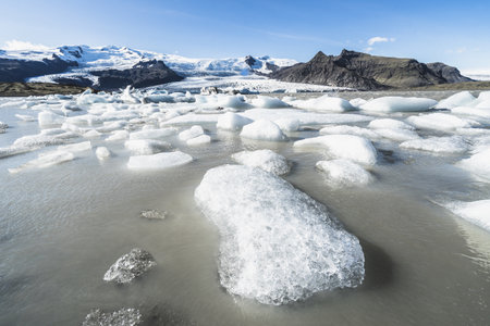 A scenic view of icebergs floating in Fjallsarlon glacier lagoon, Icelandの写真素材