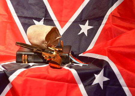 The Holy Bible, bull scrotum, bullets, and revolver on the rebel flagの写真素材