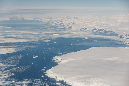 An aerial view of the snowy ice-covered landmass in Antarctica