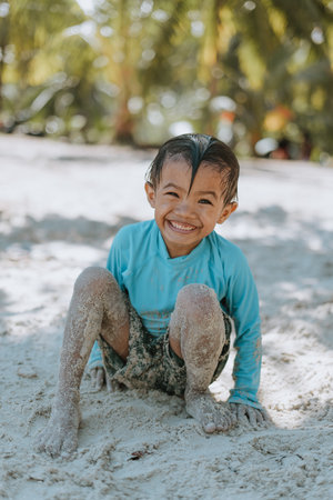 Portrait of a Cheerful Kid Playing on a White Sand Beachの写真素材