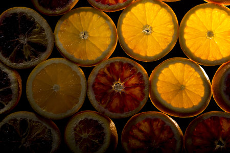 A background of fresh orange slices on a dark backgroundの写真素材