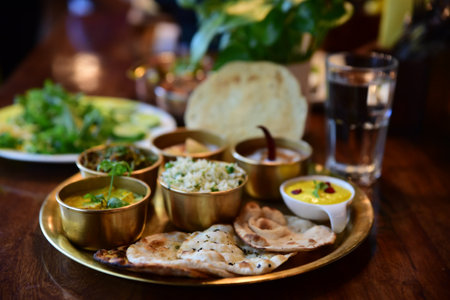 A closeup shot of an Indian tasty food called "Marwari Veg Thali" on the wooden tableの写真素材