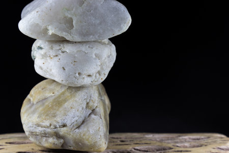 A closeup shot of a stack of stones against a black backgroundの写真素材