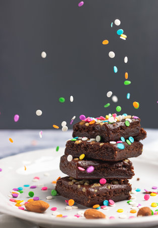 The delicious chocolate brownies with colorful sprinklesの写真素材