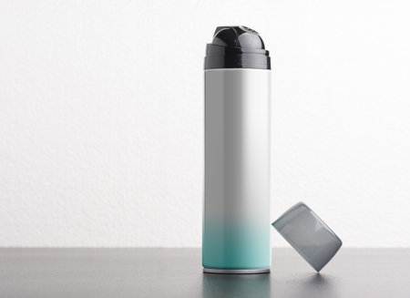 A metal bottle for shaving foam on a white background