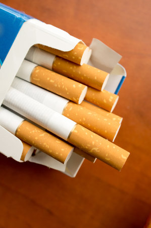A vertical closeup shot of an open pack of cigarettesの写真素材