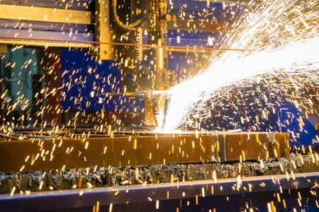 A closeup shot of sparks flying from an industrial steel cutter