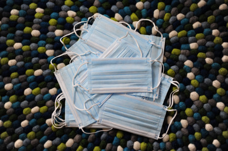 A pile of face masks on a carpet
