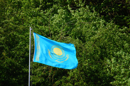 The flag of Kazakhstan flies in the wind in an allotment garden in Frankfurt.の写真素材
