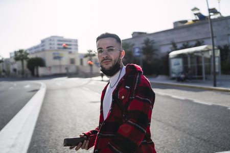 A closeup shot of a young Spanish guy crossing the street outdoorsの写真素材