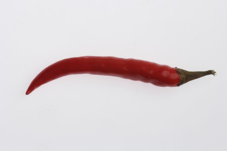 A shot of a red ripe chili hot pepper isolated on white background.