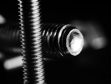 A studio grayscale of screws on black backgroundの写真素材