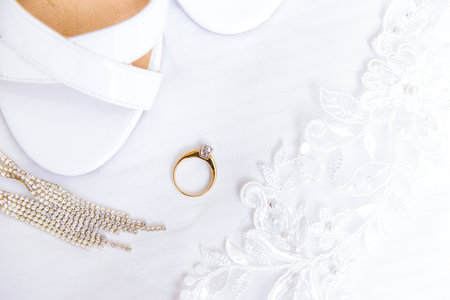 Engagement jewelry and bridal shoes on white backgroundの写真素材