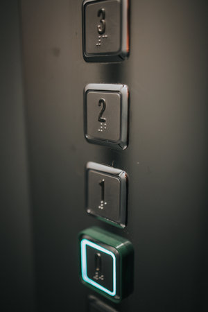 A vertical shot of elevator metal buttons