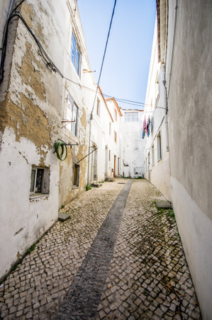 A vertical shot of a narrow alley in Almada, Lisbon, Portugalの写真素材
