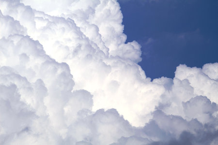 A low angle shot of the beautiful fluffy clouds in the blue skyの写真素材