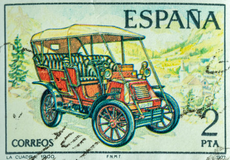 A closeup view of an old Spanish banknote with a vintage car on a green backgroundの写真素材