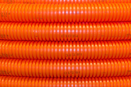 A closeup of orange electrical wire conduitのeditorial素材