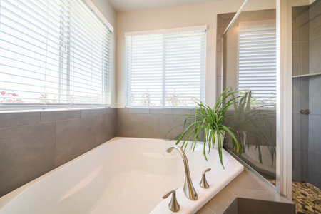 A modern interior of a bathroom with a big bathtub and wi