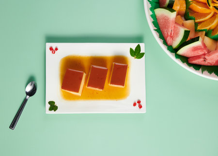 A top view of sweet pastry and freshly cut fruits