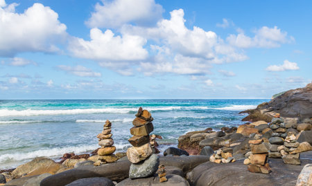 A closeup shot of rocks in Santinho Beach in Brazil on a cloudy sky backgroundの写真素材