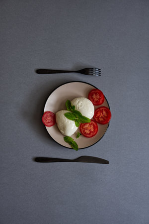 A vertical shot of delicious Caprese (mozzarella and tomato salad)の写真素材