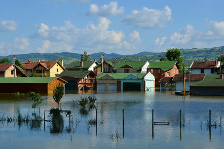 A mesmerizing view of flooded houses by the river after the rainsの写真素材